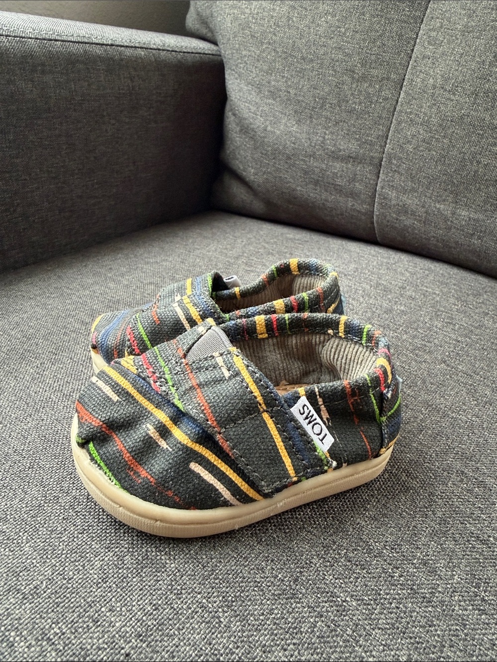 TOMS Baby Slip-On Shoes in Black with Multicolor Stripes